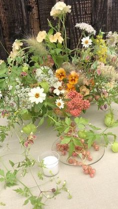 a table topped with lots of different types of flowers