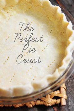 an uncooked pie crust sits in a glass dish on a wooden table top