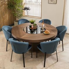 a round table with blue chairs around it