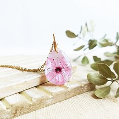 This Cherry blossom necklace is part of my cherry blossom jewelry collection. The sakura flower is highly admired in Japan, so take this sakura flower necklace with you to wear a little piece of this magic beauty. This real flower necklace will never make you go unnoticed because it is really elegant and unique. A cherry blossom necklace to have the Spring always with you... The chain is made of hypoallergenic stainless steel. The resin provides this cherry blossom necklace a perfect crystalline Dainty Blossom Flower Jewelry, Delicate Blossom Color Necklaces, Feminine Blossom Flower Jewelry, Elegant Blossom Necklace With Flower Charm, Feminine Flower-shaped Necklaces For Gifts, Blossom Petal Shaped Jewelry For Gifts, Feminine Flower Pendant Necklace As A Gift, Delicate Blossom-colored Jewelry For Gifts, Delicate Blossom Colored Jewelry As Gift