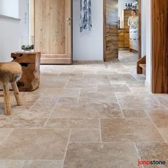 an entry way with wooden doors and two stools