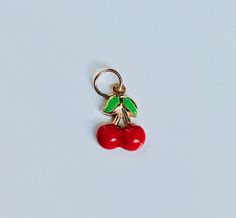 "A beautiful 14K solid yellow gold Red Cherry puffy charm / pendant with hand painted and baked enamel. It has a soldered ring to attach to a bracelet or a necklace. The small pendant measures 10mm (0.39\") tall with bail and without the soldered ring and 7.3mm (0.29\") wide. It can be used as a necklace pendant or a bracelet charm and would make a perfect gift. The pendant can be paired with a shiny 14K Yellow Gold 1.2mm cable link chain in either 16\" or 18\" length or with a 16\" 14K gold-pla Enamel Round Pendant Charms For Gifts, Yellow Gold Enamel Charms For Gift, Nickel-free Enamel Pendant Charm Necklace, Nickel Free Enamel Pendant Charms, Red Pendant Charm Necklace, Nickel-free Enamel Pendant Charms, Enamel Charm Pendant Necklace, Enamel Pendant Charm Necklace, Red Enamel Jewelry With Charms