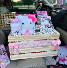 a hello kitty themed car trunk filled with stuff animals and other items in the back seat