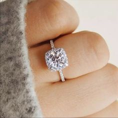 a woman's hand with a diamond ring on it