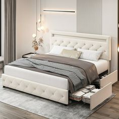 a white bed sitting next to a window on top of a wooden floor in a bedroom