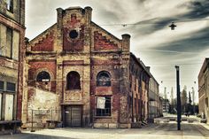 an old brick building on the corner of a street