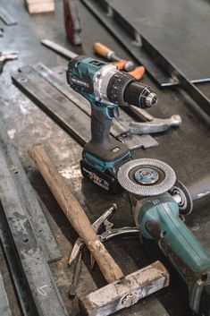 a cordless driller sitting on top of a piece of wood