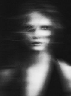 a blurry photo of a woman's face in black and white