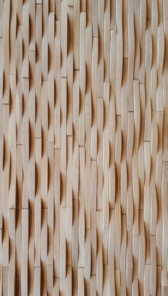 the wooden wall is made up of many different shapes and sizes, including wavy lines