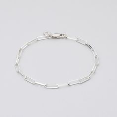 Sterling Silver bracelet on grey background Everyday Sterling Silver Chain Bracelet With Adjustable Chain, Silver Chain Link Bracelet For Everyday, Classic Silver Chain Bracelet For Everyday, White Gold Chain Bracelet With Lobster Clasp For Everyday, Everyday White Gold Chain Bracelet With Lobster Clasp, Everyday White Gold Chain Link Bracelet, Classic White Gold Paperclip Bracelet For Everyday, Everyday Chain Bracelet With Rectangular Links, Sterling Silver Bracelet With Solid Links For Everyday Wear