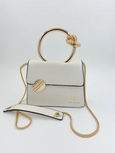 Gold circular handle structured handbag with detachable crossbody chain. Chic Satchel With Adjustable Strap And Round Handle, Chic Clutch With Adjustable Strap And Top Handle, Chic Top Handle Clutch With Adjustable Strap, Chic Clutch With Detachable Strap, Chic Gold Shoulder Bag With Round Handle, Chic Top Handle Clutch For On-the-go, Gold Bag With Removable Pouch And Round Handle, Gold Bags With Removable Pouch And Round Handle, Trendy Evening Bag With Gold-tone Hardware And Top Handle