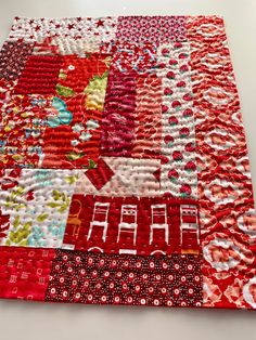 a red and white patchwork quilt on a table