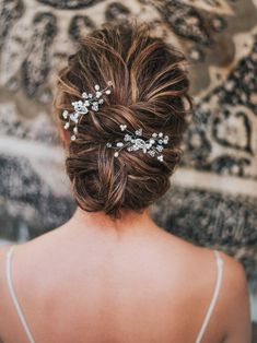 the back of a woman's head wearing a bridal hair piece