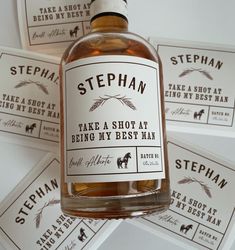 a bottle of stephan take a shopah being my best man cologne sitting on top of some business cards