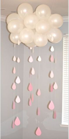 some white and pink balloons hanging from the ceiling