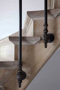 the stair railings are made from wood and metal, with an iron handrail