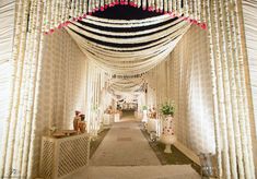 the entrance to an indoor wedding venue decorated in white and pink