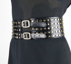 This 3in (8cm ) wide belt with metal buckles and gold metal studs is made of stiff calf leather with a gloss finish. With to its unique design, this belt will accentuate the waist and create a flattering feminine shape. This belt will fit many styles - Steampunk, Biker, Goth, Punk, Cowboy. You can wear this corset belt with dresses and blouses, it can even be worn over a cloak or jacket. Add this fashionable item to your wardrobe and you will not leave anyone indifferent! Other models of wide wa Edgy Corset Belt With Belt Loops For Night Out, Edgy Corset Belt With Removable Belt For Night Out, Trendy Corset Belt With Belt Loops For Party, Gothic Corset Belt For Party With Belt Loops, Trendy Corset Belt For Parties, Includes Belt, Trendy Corset Belt For Party, Black Chain Belt With Belt Loops For Festivals, Trendy Belt Buckles With Matching Belt For Party, Black Chain Belt For Festival