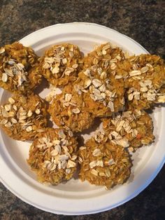 a white plate topped with cookies covered in granola