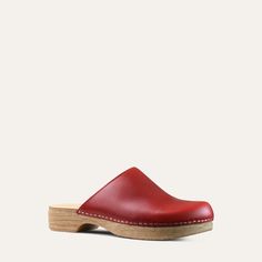 The Helena classic clog is one of our all-time favorites. It has the look of a traditional clog but on a flat base. Red leather. With its cushioned, flexible sole, the Helena clog is both stylish and easy to wear. Designed in Sweden and handmade in Italy. Heel: 3cm / 1.18" Inches Soft Padded footbed Flexible base with wood-like effect Classic Clogs With Wooden Heel And Round Toe, Casual Closed Toe Clogs With Branded Insole, Leather Closed Toe Clogs With Rubber Sole, Casual Clogs With Red Sole And Round Toe, Classic Leather Clogs With Flat Heel, Comfortable Flat Clogs With Rubber Sole, Classic Mules With Rubber Sole And Round Toe, Classic Slip-on Clogs With Rubber Sole, Red Casual Mules With Rubber Sole