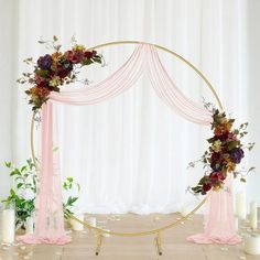 a wedding arch decorated with flowers and candles