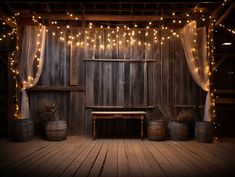 an old wooden room with lights strung from the ceiling and two barrels on the floor