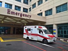 an ambulance is parked in front of the emergency building