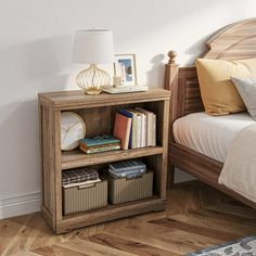 a bedroom with a bed, nightstand and bookshelf on the end table in front of the bed