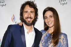 a man and woman standing next to each other on a red carpet at an event