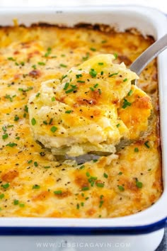 a spoonful of mashed potato casserole in a blue and white dish