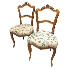 two antique chairs with floral upholstered seats