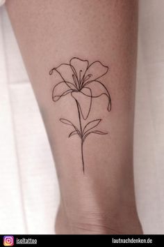 a small flower tattoo on the ankle that is black and white, with thin lines