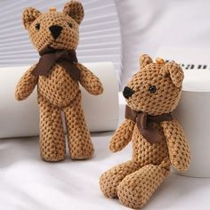 two crocheted teddy bears sitting next to each other