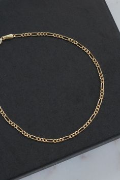 "18k Solid Gold Figaro Chain Bracelet. Length: 6 5/8\" Width: 1mm Weight: 0.74 grams Marked: 750 (18k solid gold) Back to the shop: https://www.etsy.com/shop/SusVintage?ref=hdr_shop_menu If you have any questions feel free to contact me. Thank you!!" Luxury Oval Link Chain Bracelet With Figaro Chain, Luxury Figaro Chain Bracelet With Oval Link, Luxury Gold Bracelet With Figaro Chain, Luxury Bracelet With Figaro Chain And Oval Link, Gift Chain Bracelet With Rectangular Links, Luxury 14k Gold Bracelet With Figaro Chain, Luxury Figaro Chain Bracelet As Gift, Luxury Figaro Chain Bracelet, Gold Bracelet With Figaro Chain And Rectangular Links