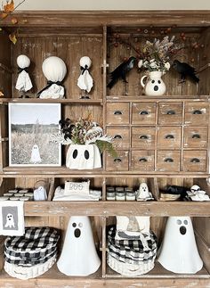 an old wooden cabinet with halloween decorations on top and other items in the bottom shelf