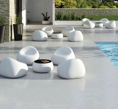 white chairs sitting next to a swimming pool