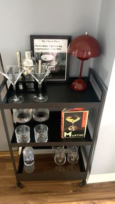 a black shelf with glasses on top of it