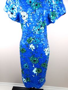 "This is a fully embellished vintage dress covered in bright blue and green sequins. The material is 96% cotton and 4% spandex, so there's is a little stretch in the material. It's in perfect condition! Measurements are taken not stretched and stretched: Size MEDIUM Measurements: Bust - 36-40\" Waist - 28-32\" Hips - 36-40\" Length - 43\" Size XL Measurements: Bust - 40-44\" Waist - 32-36\" Hips - 40-44\" Length - 43\" This dress comes from a pet-free and smoke-free home. If you would like more Fitted Dresses With Contrast Sequin And Short Sleeves, Fitted Short Sleeve Dresses With Contrast Sequin, Fitted Sequin Dress With Short Sleeves For Summer, Spring Green Sequin Dress With Contrast Sequins, Green Sequin Dress With Contrast Sequin For Spring, Blue Sequined Fitted Dress, Blue Embellished Sequin Summer Dress, Blue Fitted Sequin Dress, Blue Embellished Sequin Dress For Summer