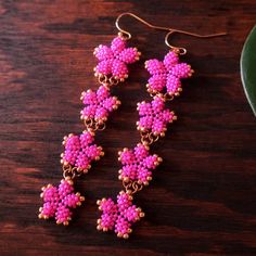 pink beaded earrings on a wooden table