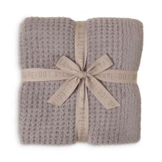 two grey knitted blankets tied together with a ribbon and the words,'we need to