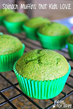 green muffins sitting on a cooling rack with the words spinach muffins that kids love