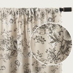 an image of a curtain with flowers on it and a black rod handle hanging from the side