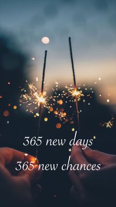 two hands holding sparklers with the words, 365 new days 535 new changes