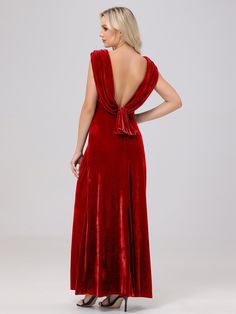 a woman wearing a red velvet dress with a backless neckline and open shoulders