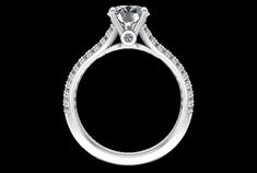 a round cut diamond engagement ring with pave set shoulders