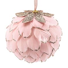 a pink ornament with feathers hanging from it's side on a white background