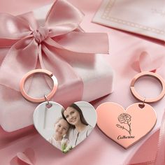 two heart shaped keychains with a photo on them