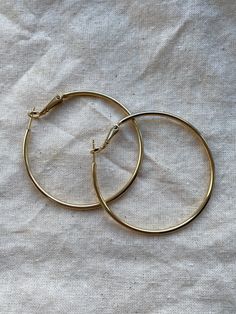 "Simple pair of gold plated earrings Size is 50mm in diameter (2\")" Gold-tone Hypoallergenic Hoop Earrings, Hypoallergenic Gold-tone Hoop Earrings, Gold-tone Metal Circle Hoop Earrings, Gold-tone Nickel-free Round Hoop Earrings, Nickel-free Gold-tone Hoop Earrings, Gold Hoop Earrings With Ear Wire, Gold Plated Cadmium-free Hoop Earrings, Cadmium-free Gold Plated Hoop Earrings, Gold Hypoallergenic Hoop Earrings