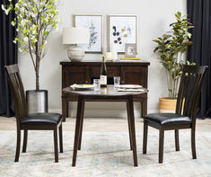 a dining room table with two chairs and a vase filled with flowers on top of it