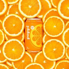 an orange soda can surrounded by sliced oranges